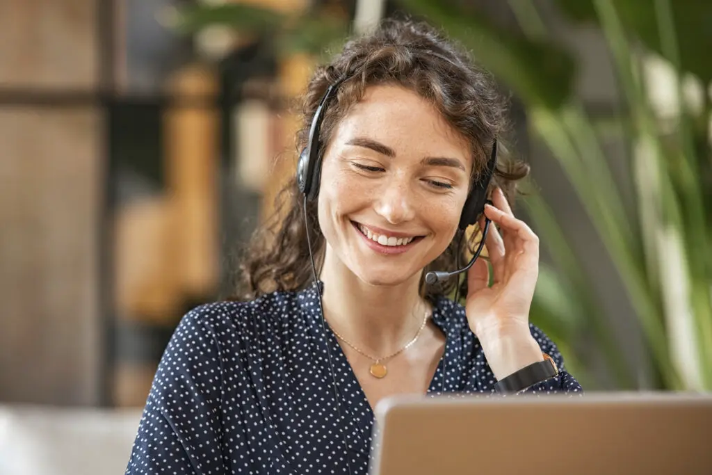Junge lächelnde Frau mit einem Headset